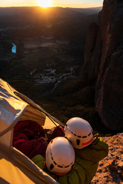 Climbers resting inside a wall portaledge at mountain