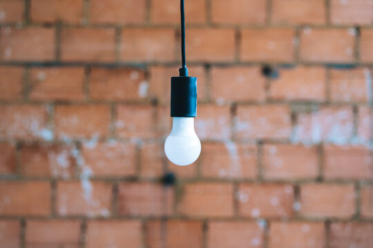 A light bulb with brick background
