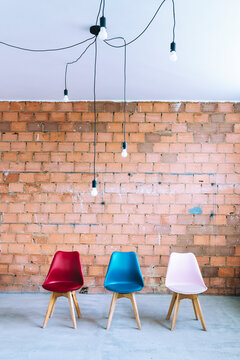 Chairs and light bulbs on industrial background

