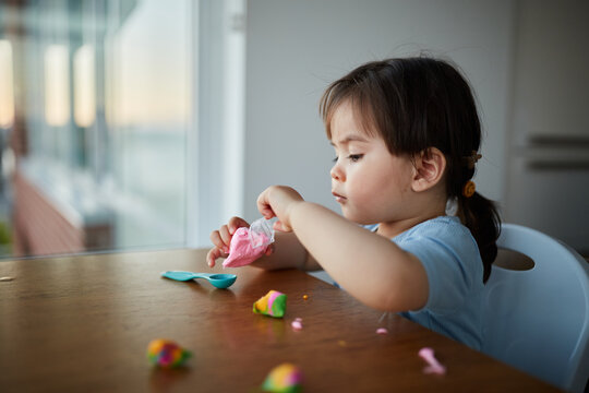 Young Mixed Race Chinese Girl Plays With Play Dough