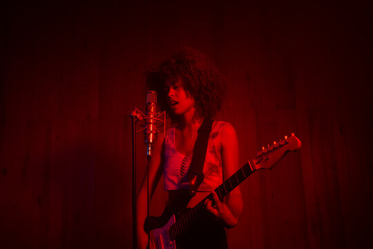 Female Musician Playing Music In The Studio.