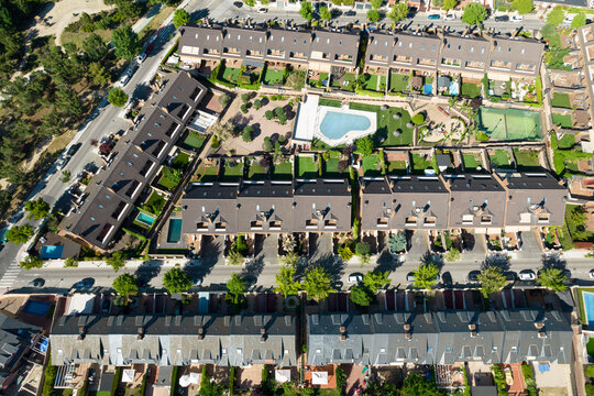 aerial view of a residential area of houses with swimming pool in a sunny summer day