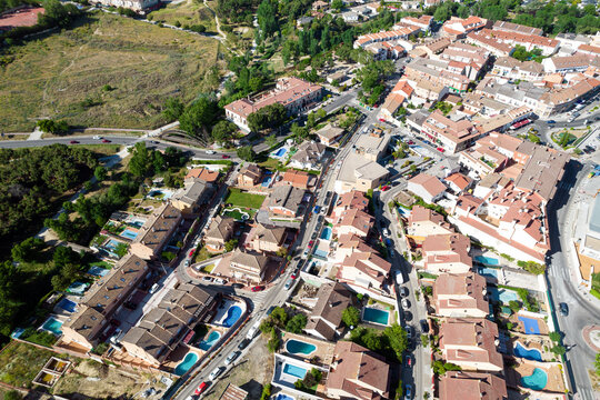 aerial view of a residential area of houses with swimming pool in a sunny summer day