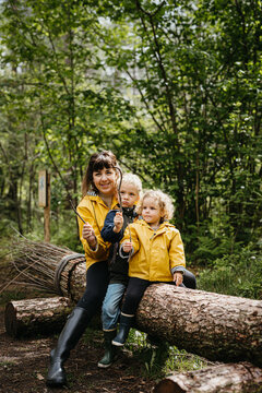Mother with two kids walking a witch themed trail in the forest
