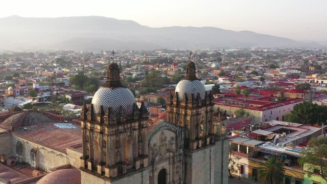 Aerial View, Domes, Towers and Facade of Santo Domingo de Guzman Church, Oaxaca City Mexico, Landmark of Historic Colonial Downtown, Parallax Drone Shot