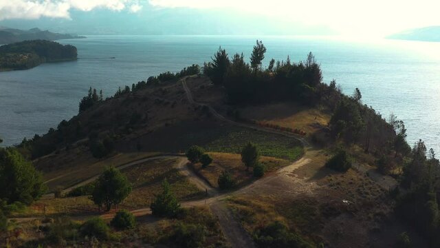 Drone Aerial View of Laguna de Tota, Boyaca Region, Colombia. Hills Above Lake Under Andes and Cloudy Skyline