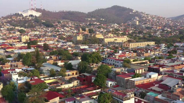 Oaxaca Cityscape, Mexico. Aerial View, Old Spanish Colonial Buildings, Downtown and Santo Doming de Guzman Church on Golden Hour Sunlight, Flying Above Drone Shot