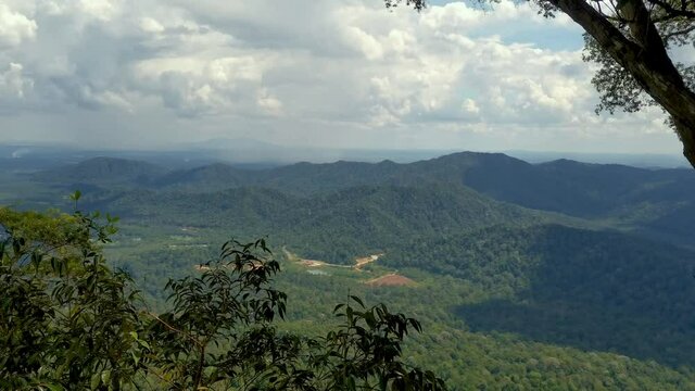 Aerial shot of tropical rainforest mountains, Gunung Panti, Malaysia. Mountains, peaks, cliffs, rocks, ridges, landscape, green grass, sky, clouds, nature, uncultivated nature, view from mountain peak