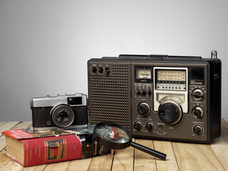 Old camera, radio and book about century XX