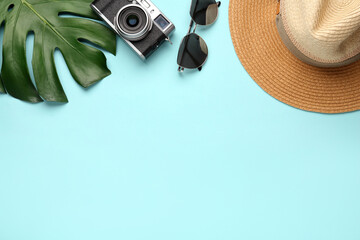 Flat lay composition with straw hat on turquoise background. Space for text