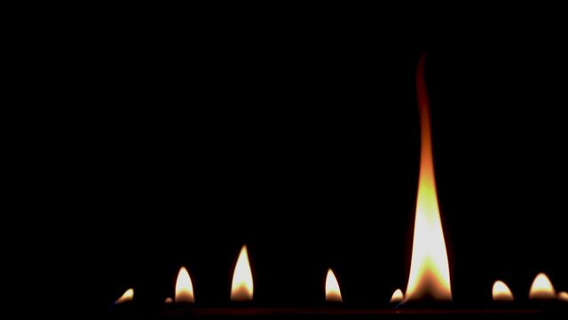 B roll of Close-up of flames burning slow motion background footage. Flames fire on black background. Burning fire. Bonfire. 
