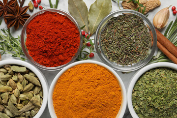 Flat lay composition with different natural spices and herbs on table