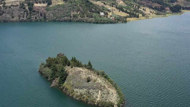Aerial View of Island in Laguna de Tota, Boyaca Largest Lake in Colombia. Scenic Coastline and Landscape, Orbit Drone Shot