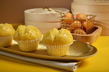 traditional local steam yellow cup cake huat kueh dessert with beautiful display in Pantone color background new asian halal dim sum menu