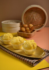 traditional local steam yellow cup cake huat kueh dessert with beautiful display in Pantone color background asian halal dim sum menu