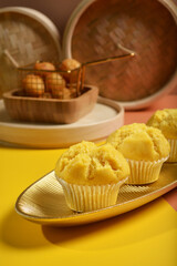 traditional local steam yellow cup cake huat kueh dessert with beautiful display in Pantone color background new asian halal dim sum menu