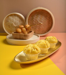traditional local steam yellow cup cake huat kueh dessert with beautiful display in Pantone color background new asian halal dim sum menu