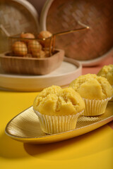 traditional local steam yellow cup cake huat kueh dessert with beautiful display in Pantone color background new asian halal dim sum menu