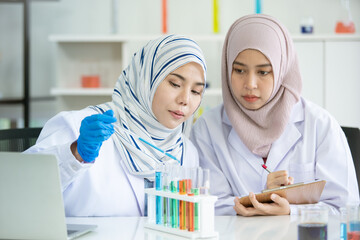 Asian young Muslim scientist testing the chemical experiment in laboratory.