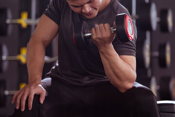 Fototapeta na wymiar Asian young man practice weight training workout in the gym, body building exercise. 