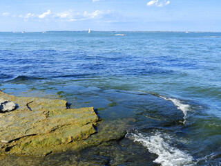 rocky coastline  and waves in summernear the marblehead lighthouse  near sandusky, ohio