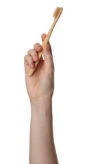 Woman holding eco friendly bamboo toothbrush on white background, closeup. Conscious consumption