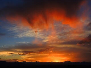 colorful sunset and Virga clouds over the front range of the Rocky Mountains, as seen from...