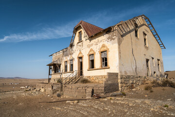 Fototapeta na wymiar Abandoned building in the Kolmanskop ghost town near Luderitz, Namib Desert, Namibia. 