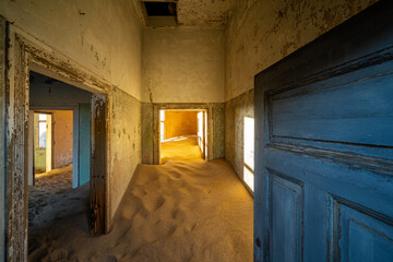 Abandoned building being taken over by encroaching sand in the ghost town of Kolmanskop near...