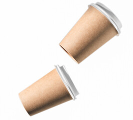 carton cups of coffee isolated on white background. levitating cardboard eco coffee to go cups with white lids, selective focus