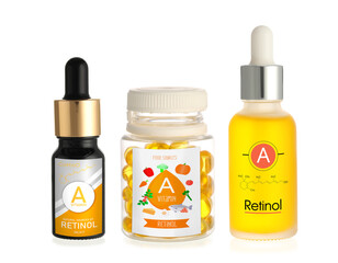 Bottles of vitamin A pills and oil on white background