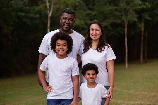 Diversity Family With Afro Father And Japanese Mother. Beautiful Happy Family In The Park