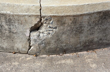 The edge of the cement footpath is broken