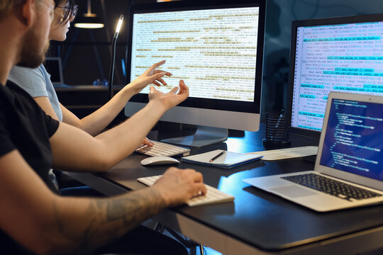 Young Programmers Working With Computer In Office At Night