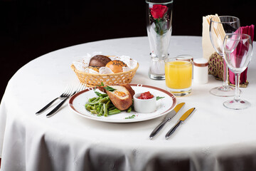 A set table in the restaurant. Cutlet with beans and hot sauce.