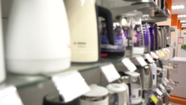New Electric Kettles in the Store. Close-up. Nobody. Blurred Video. JIB