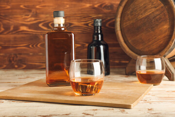 Bottle and glass of cold whiskey on table