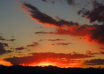 fiery sunset over the front range of the rocky mountains as seen from broomfield, colorado