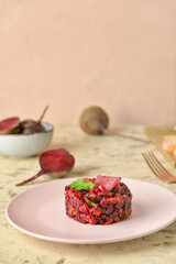Plate with tasty tartare salad on table