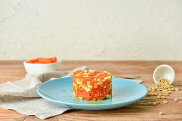 Plate with tasty tartare salad on light background