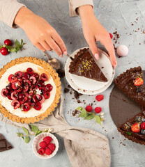 Different types of homemade tarts on light gray background.