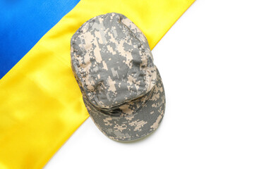 Military cap and flag of Ukraine on white background