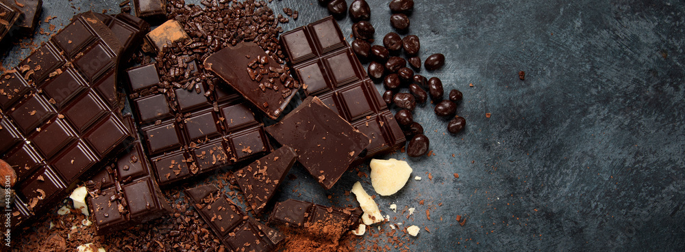 Wall mural cacao beans and chocolate on gray background.