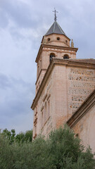 Church of Santa Maria de Alhambra near to the palace of Carlos V in cloudy day. Granada, Spain,...