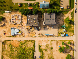 Top down view three buildings roof tops in construction site in residential area. Real estate development concept.
