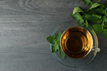 Cup of nettle tea on dark wooden table
