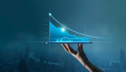 Businessman holding tablet and display graphs growth of business on virtual interface and stock...