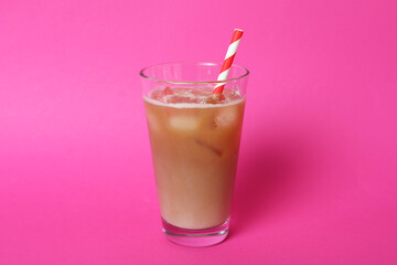 Glass of ice coffee on pink background