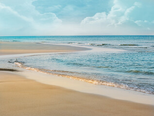 Tropical beach with golden sand, Relaxing vacation, Turquoise sea against blue sky on sunny summer day background.