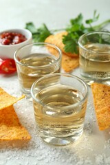 Party concept with tequila, guacamole and chips